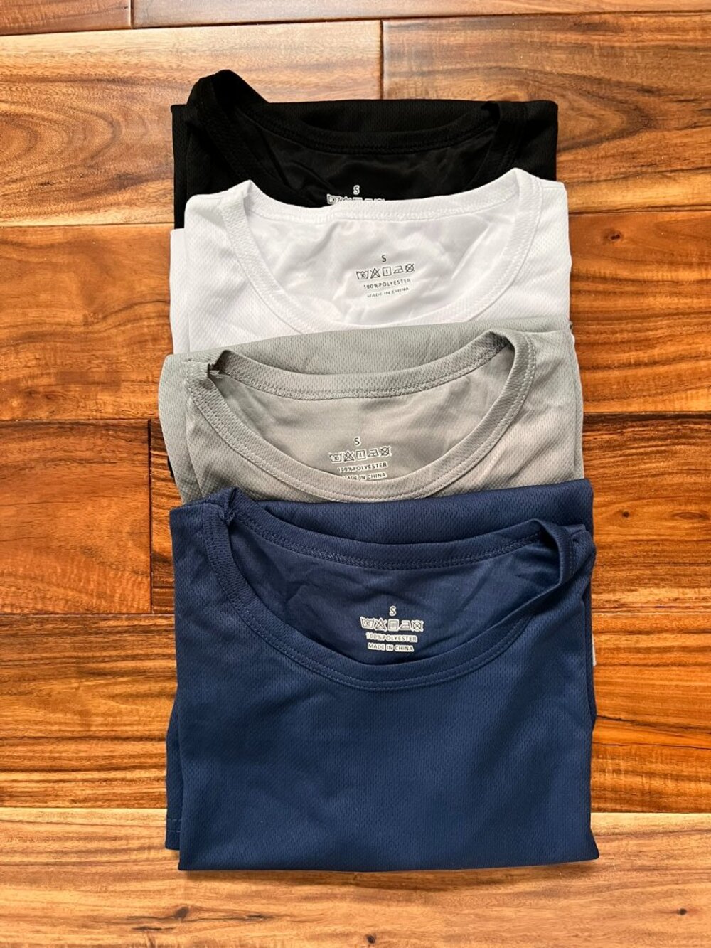 Set of four new without tags lightweight athletic/performance-style shirts.